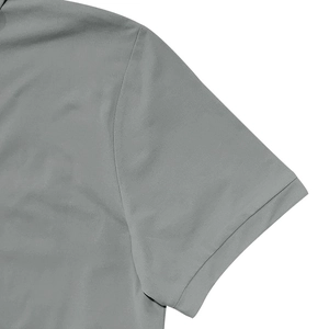 Detail of shoulder seam and sleeve hem on a men's grey casual short sleeve polo shirt
