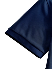 Detail view of double-stitched cuff on navy blue polo shirt with premium finish