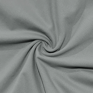 Close-up of gray knit fabric showing the fine diagonal twill texture and soft drape