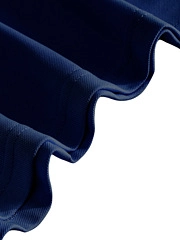 Macro detail of navy blue quick-dry fabric with knitted texture and wavy hem edge