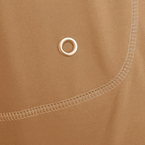 Detailed macro shot of deep camel knit fabric featuring metal eyelet and neat stitching