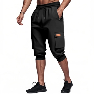 Detail of black heavy cargo shorts showing elastic drawstring waist and side flap pocket
