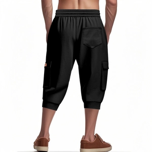 Detail view of men's black cargo shorts featuring elastic waist and large side pockets