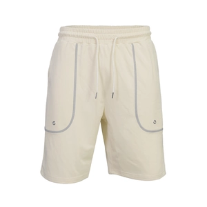 Detail of cream men's athletic shorts featuring elastic waist and reflective pocket trim