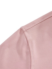 Detail of double-needle stitching on light pink breathable fabric for polo shirt