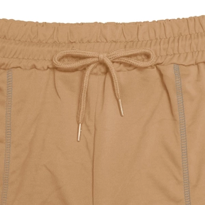 Detail view of khaki sports shorts featuring elastic waistband and metal tip drawstrings