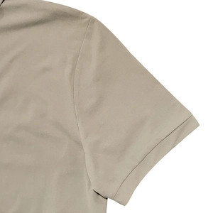 Close-up of khaki short-sleeve polo shirt with detailed stitching and premium cotton texture