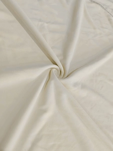 Close-up of cream knit fabric texture showing softness and drape for men's sports set