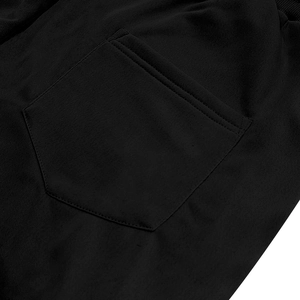 Detailed close-up of the reinforced back pocket stitching on heavy black cargo shorts