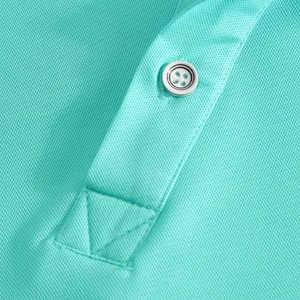Macro detail of breathable piqué fabric and placket with button on mint green polo shirt