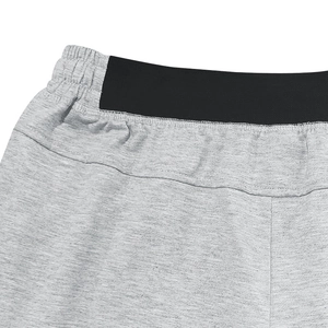 Detail of grey men's sports shorts featuring elastic waistband and reinforced stitching