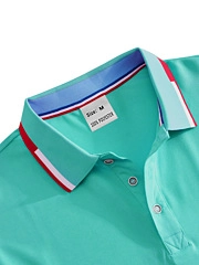 Close-up of mint green polo shirt collar with striped trim and size M tag