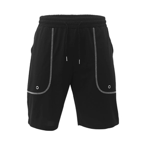 Detail of black sports shorts featuring white U-shaped stitching and drawstring waistband