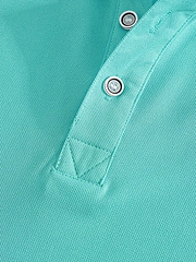 Macro detail of mint green polo shirt neckline with piqué mesh texture and silver buttons