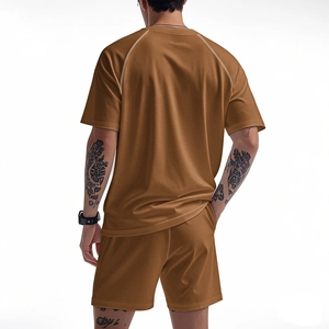 Detail of men's quick-dry tracksuit showing caramel brown raglan tee and white contrast stitching