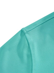 Detailed close-up of breathable mesh fabric and flat shoulder seams on mint green polo shirt