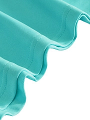 Detailed close-up of light blue polo fabric with wavy hem and double stitching