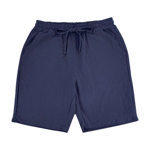 Detailed macro view of deep blue linen fabric texture and elastic waistband with drawstring
