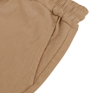 Detail of khaki linen shorts with elastic drawstring waistband and side pockets