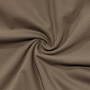 Macro texture detail of coffee brown ribbed polo shirt fabric showing stretch and weave