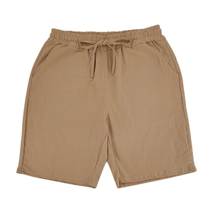 Detail of khakilinen shorts showing elastic waistband, drawstring and breathable fabric
