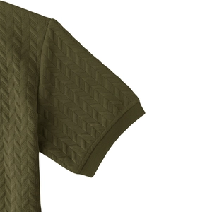 Detail of olive green heavy jacquard fabric showing herringbone texture and ribbed cuff