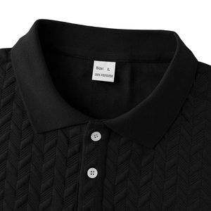 Detailed macro view of black men's Polo shirt featuring textured jacquard fabric and buttons