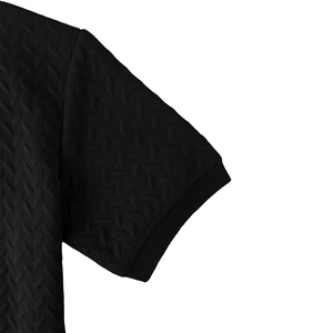 Close-up of black men's Polo shirt featuring chevron textured fabric and ribbed cuffs