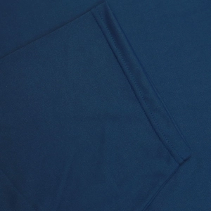 Macro shot of dark blue quick-dry fabric showing breathable mesh and double-needle stitching