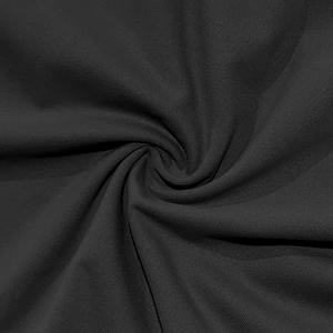 Close-up of premium black ribbed polo shirt fabric showing detailed twill texture