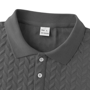 Macro shot of dark grey polo shirt showing heavy jacquard knit texture and size label