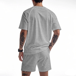 Rear view of men's grey sports set featuring raglan sleeve tee and breathable shorts