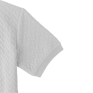Macro view of light grey men's Polo shirt with textured herringbone quilting and ribbed cuffs