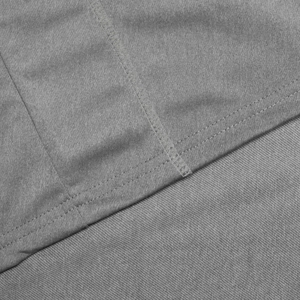 Detail of grey quick-dry fabric showing precise double-needle stitching and knit texture