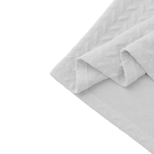 Detailed view of white herringbone jacquard fabric with premium stitched hem edges
