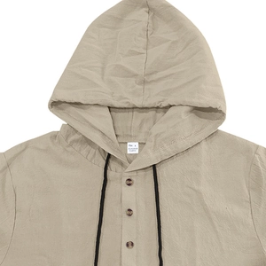 Detail of light khaki linen-textured shirt collar with three buttons and black drawstrings