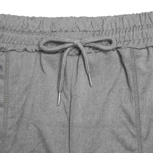 Detail of grey athletic shorts featuring an elastic waistband and metallic aglet drawstring
