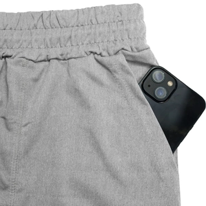 Detail of side pocket on grey knitted sports shorts showing deep storage for smartphones