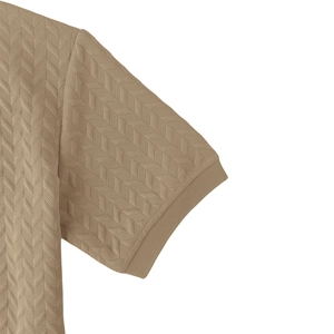 Close-up of khaki polo shirt with textured herringbone knit fabric and ribbed cuffs