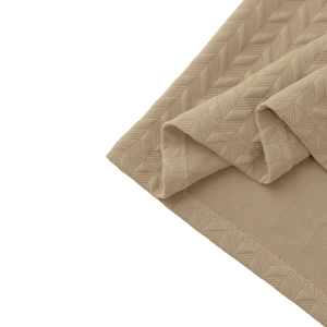 Macro detail of khaki knit polo shirt hem showing high-quality herringbone fabric texture
