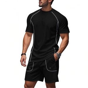 Detail of men's black athletic set featuring white contrast stitching on T-shirt and shorts