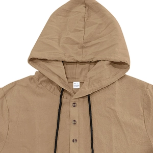 Detail of khaki linen Henley shirt showing fabric texture, 3-button placket and black drawstring