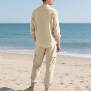 Men's linen set featuring mandarin collar shirt and cargo pants on a beach background