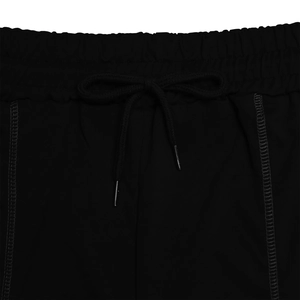 Close-up of black sports shorts featuring elastic waistband and metal-tipped drawstring