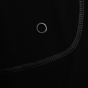 Detail of metal grommet and professional flatlock stitching on black quick-dry sportswear