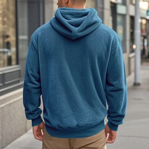 Street style back view of a teal men's hoodie with thick fleece fabric and ribbed hem