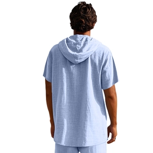 Detail of light blue linen blend fabric texture on men's hooded shirt and pants set