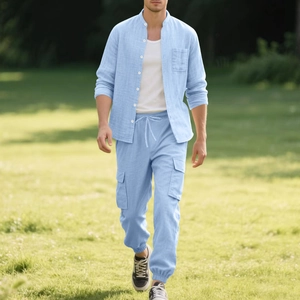 Detail of light blue linen shirt set featuring stand collar and cargo pockets on pants