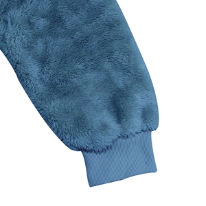 Detailed close-up of blue plush hoodie sleeve with elastic ribbed cuffs for men