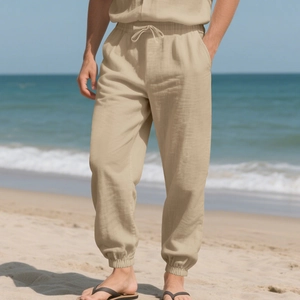 Detail of men's linen jogger pants featuring drawstring waist and breathable fabric texture